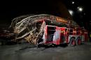 In this May 5, 2014 photo released by the National September 11 Memorial Museum, a firetruck, damaged in the attacks of September 11, 2001, is on display at the New York museum. The long-delayed museum will be dedicated during a ceremony Thursday, May 15, 2014. (AP Photo/ National September 11 Memorial Museum, Jin Lee)