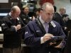 Michael Urkonis, right, works with fellow traders on the floor of the New York Stock Exchange, Friday, March 9, 2012. Stocks rose Friday morning after the February jobs report bolstered hopes that the economic recovery is on track. (AP Photo/Richard Drew)