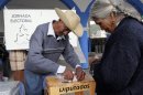People cast their votes in a ballot box reading "Delegates" in Santiago Xalitzintla