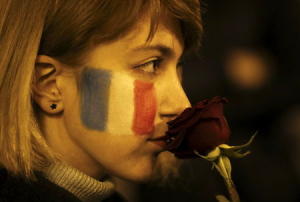 A woman with French flag painted on her face, holds&nbsp;&hellip;