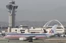 An4 American Airlines Boeing 767 awaits to take off at the Los Angeles International airport in Los Angeles on Wednesday, April, April 30, 2014. Flights from airports in the Los Angeles area were grounded for more than an hour Wednesday afternoon due to computer failure at an air traffic control facility in the region. (AP Photo)