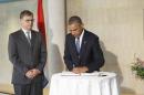 President Barack Obama visits the Dutch Embassy in Washington to sign a book of condolence, joined by Deputy Chief of Mission Peter Mollema, Tuesday, July 22, 2014. Most of the 298 people aboard the Malaysia Airlines plane that was shot down near the border between Ukraine and Russia were Dutch citizens. (AP Photo/J. Scott Applewhite)