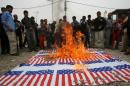 File picture from 2009 shows Iraqi Shiite Muslims burning replicas of the US flag following the conviction of former US soldier Steven Dale Green of raping an Iraqi teenager and executing the girl and her family