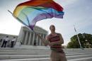 In this June 26, 2013, file photo, gay rights advocate Vin Testa waves a rainbow flag in front of the Supreme Court in Washington. The justices might have to decide to jump in at their closed-door conference on Friday, Jan. 16, 2015, if they want to resolve the legal debate over gay marriage in the next few months. The justices would hear the case in April, the last month for oral arguments before the next term begins in October. (AP Photo/J. Scott Applewhite, File)