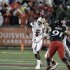 Louisville quarterback Teddy Bridgewater (5) throws a pass as Cincinnati linebacker Adam Dempsey (91) defends during the first half of an NCAA college football game in Louisville, Ky., Friday, Oct. 26, 2012. (AP Photo/Garry Jones)