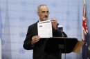 Syrian U.N. Ambassador Bashar Ja'afari shows a document to reporters at the United Nations Headquarters in New York