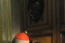 Cardinal Tarcisio Bertone seals the door of the apartment of Pope Benedict XVI at the Vatican