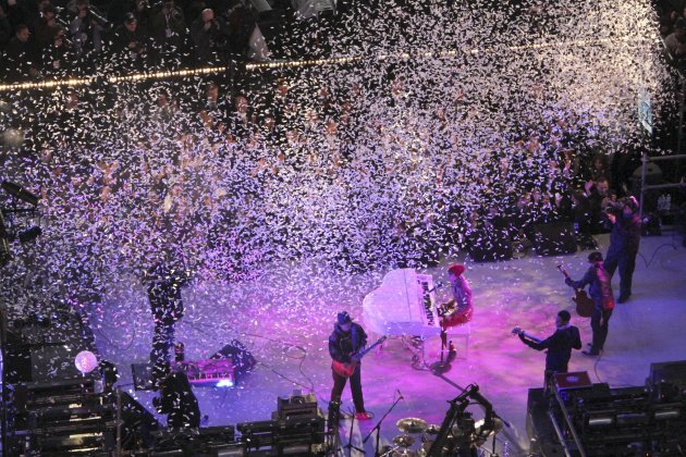 Justin Bieber, center, and Carlos Santana, foreground left, perform during the New Year's Eve celebration as seen from the balcony of the Marriott Marquis hotel, Saturday, Dec. 31, 2011, in New York. 