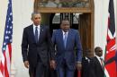 U.S. President Barack Obama arrives together with Kenya's President Uhuru Kenyatta to hold a joint news conference after their meeting at the State House in Nairobi