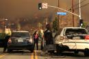 Motorists exchange information after a car accident as a wildfire burns in the hills just north of the San Gabriel Valley community of Glendora, Calif. on Thursday, Jan 16, 2014. Southern California authorities have ordered the evacuation of homes at the edge of a fast-moving wildfire burning in the dangerously dry foothills of the San Gabriel Mountains. (AP Photo/Ringo H.W. Chiu)