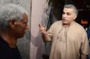 Activist Nabeel Rajab speaks to his neighbour after his release from jail, in Bani Jamra