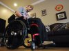 In this Jan. 31, 2012 photo, Marine Sgt. Ben Tomlinson checks his cell phone for messages after working out at his home in Jacksonville, Ala. Tomlinson was badly injured in Afghanistan and is now using a wheelchair because of paralysis. Tomlinson's hometown gave him a homecoming celebration that he said inspired him to work even harder on his rehabilitation. (AP Photo/Jay Reeves)