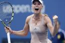 Caroline Wozniacki, of Denmark, reacts after defeating Maria Sharapova, of Russia, during the fourth round of the 2014 U.S. Open tennis tournament, Sunday, Aug. 31, 2014, in New York. (AP Photo/Kathy Willens)