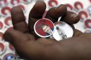 Badges showing an image of Egypt's President Mohamed Mursi and the words "Yes to constitution" are displayed at a street stall outside Al Azhar mosque in old Cairo