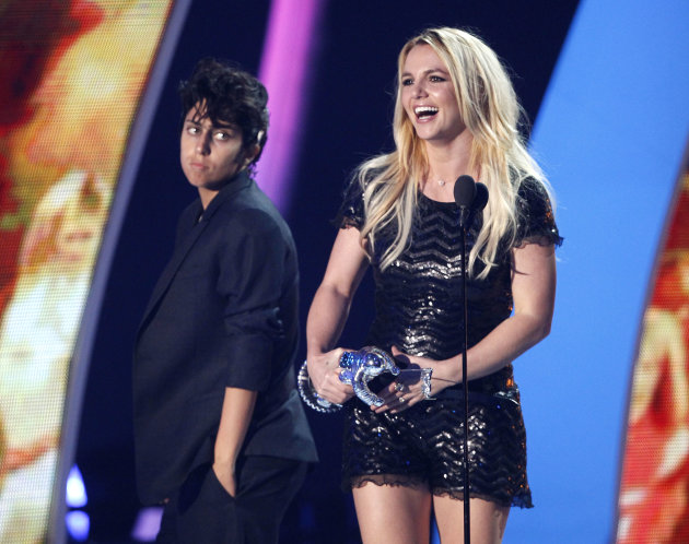 Britney Spears accepts the Video Vanguard award at the MTV Video Music Awards on Sunday Aug. 28, 2011, in Los Angeles. In background looking on at left is presenter Lady Gaga. (AP Photo/Matt Sayles)