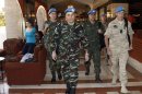 A team of U.N. monitors walk through a hotel in Damascus