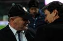 Roma coach Rudi Garcia, right, shares a word with Palermo coach Giuseppe Iachini prior to the start of the Serie A soccer match between Palermo and Roma in Palermo, Italy, Saturday, Jan. 17, 2015. (AP Photo/Alessandro Fucarini)