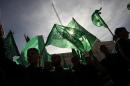 Palestinian protestors hold up the Hamas Islamist movement flag during a rally in the West Bank city of Ramallah on November 16, 2012