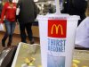 In this Jan. 20, 2012 photo, the McDonald's logo is displayed on a drink as customers purchase lunch at McDonald's, in Springfield, Ill. McDonald’s Corp. saw net income jump by 11 percent in the fourth quarter, as the fast-food giant continued to attract budget-conscious customers with low prices. (AP Photo/Seth Perlman)