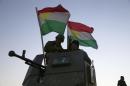 Kurdish Peshmerga fighters stand on top of a military vehicle as they advance towards villages surrounding Mosul, in Khazer, about 30 kilometers (19 miles) east of Mosul, Iraq, Monday, Oct. 17, 2016. The Iraqi military and the country's Kurdish forces say they launched operations to the south and east of militant-held Mosul early Monday morning. (AP Photo/Bram Janssen)