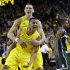 Michigan guard Trey Burke, foreground, and teammate forward Mitch McGary celebrate their 58-57 win over Michigan State in an NCAA college basketball game in Ann Arbor, Mich., Sunday, March 3, 2013. (AP Photo/Carlos Osorio)
