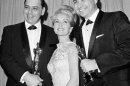 FILE - In this April, 5,1965 file photo actress Debbie Reynolds poses with Academy awards winners for best music Richard M. Sherman, right and Robert Sherman, left, who received the award for Mary Poppins in Santa Monica Calif. Songwriter Sherman, who wrote the tongue-twisting 