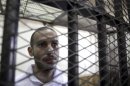 Computer science graduate Alber Saber is seen inside the cage during his trial in Cairo
