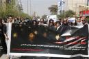 Iraqi Protesters hold banner during a demonstration against the draft of the "Al-Jafaari" Personal Status Law during International Women's Day in Baghdad