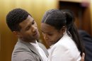 FILE - In this Friday, Aug. 9, 2013 file photo, R&B singer Usher, left, embraces ex-wife Tameka Foster Raymond after a judge dismissed an emergency request by Raymond seeking temporary custody of their two children, in Atlanta. Usher's son has been released from the hospital after nearly drowning in an Atlanta pool. A lawyer for the boy's mother said Tuesday, Aug. 13, 2013, that 5-year-old Usher Raymond V was released from Children's Healthcare of Atlanta Scottish Rite on Sunday. Attorney Angela Kinley said Tameka Foster Raymond saw her son at school Monday when he attended orientation for the new year. (AP Photo/David Goldman, File)