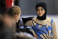 Emirati figure skater Zahra Lari (R) speaks with her coach Noemi Bedo prior performing at the European Cup, on April 12, in Canazei, northern Italy. 17-year-old Lari becomes the first Emirati figure skater to compete in an international competition with skaters from 50 countries taking part in the event