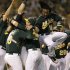 Oakland Athletics, including Jemile Weeks (19), celebrate after clinching a wild card berth in the American League at the end of a baseball game against the Texas Rangers on Monday, Oct. 1, 2012, in Oakland, Calif. (AP Photo/Ben Margot)