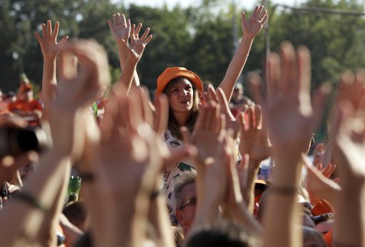 Netherlands soccer fans shout slogan as they party at the Euro 2012 fan zone in Kharkiv