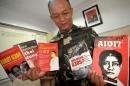 An Indonesian military officer displays books about communism in Indonesia, seized along with nearly 90 other books, from shelves inside a mall in Tegal, Central Java
