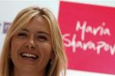 Tennis player Sharapova of Russia smiles at a news conference in New Delhi