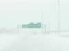 Snow blows across US Highway 218 as near whiteout conditions begin in Waterloo