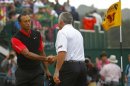 Tiger Woods shakes hands with his former caddie after finishing his final round of the British Open golf championship at Muirfield in Scotland