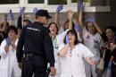 Medical practitioners shout against Spain's Prime Minister Mariano Rajoy during his visit to the Carlos III hospital in Madrid, Spain, Friday, Oct. 10, 2014. A Spanish hospital official says the nursing assistant infected with Ebola is "stable," hours after authorities described her condition as critical. She is the first person known to have caught the disease outside the outbreak zone in West Africa. She contracted the virus while helping treat a Spanish missionary who became infected in West Africa, and later died. (AP Photo/Daniel Ochoa de Olza)