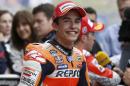 Marc Marquez of Spain smiles as he gives interviews after qualifying for the Texas MoGP race at the Circuit of the Americas Saturday, April 11, 2015, in Austin, Texas. Marquez will start Sunday's race in the pole position. (AP Photo/Tony Gutierrez)