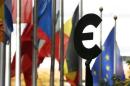 A statue depicting European unity is seen near EU flags outside the European Parliament in Brussels