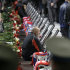 A relative of a victim sits among portraits at a funeral service for the victims of the plane crash, in the Arena Yaroslavl, 150 miles (240 kilometers) northeast of Moscow in Russia, Saturday, Sept. 10, 2011. The chartered Yak-42 jet crashed Wednesday into the banks of the Volga River moments after takeoff from an airport near Yaroslavl. The crash killed 43 people, including 36 players, coaches and staff of the Lokomotiv Yaroslavl ice hockey team, many of whom were European national team and former NHL players. (AP Photo/Misha Japaridze)