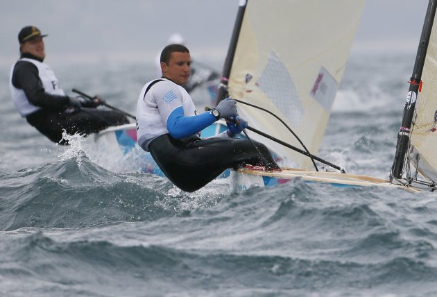 Greece's Mitakis sails ahead of Finalnd's Nirkko during the fifth race of the men's Finn sailing class at the London 2012 Olympic Games in Weymouth and Portland