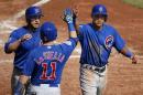 Chicago Cubs' Addison Russell, right, and Miguel Montero, left, celebrate with teammate Tommy La Stella (11) after scoring on a double by relief pitcher Clayton Richard off Pittsburgh Pirates relief pitcher Joe Blanton in the fifth inning of a baseball game in Pittsburgh, Thursday, Sept. 17, 2015. (AP Photo/Gene J. Puskar)