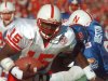 FILE - In this Nov. 11, 1995, file photo, Nebraska quarterback Tommie Frazier (15) runs to inside the one-yard line as Kansas defensive tackle Dewey Houston (83) tries to stop his progress during the first quarter of an NCAA college football game in Lawrence, Kan. Frazier was selected to the College Football Hall of Fame on Tuesday, May 7, 2013.  (AP Photo/Cliff Schiappa, File)