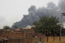 Smoke billows on the background during battles between members of the Iraqi security forces and anti-government fighters on February 3, 2014 in the city of Ramadi, west of the capital Baghdad in the Anbar province