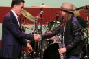 Republican presidential candidate, former Massachusetts Gov. Mitt Romney, shakes hands with Kid Rock at a campaign event at the Royal Oak Music Theatre in Royal Oak, Mich., Monday, Feb. 27, 2012. (AP Photo/Carlos Osorio)