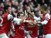 Arsenal's Santi Cazorla celebrates with team mates after scoring against Tottenham Hotspur during their English Premier League soccer match in London
