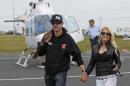 FILE - In this May 17, 2014 file photo, Kurt Busch, left, walks with his girlfriend, Patricia Driscoll, after arriving for the NASCAR Sprint All-Star auto race at Charlotte Motor Speedway in Concord, N.C. Attorneys for the NASCAR driver asked a Delaware judge on Thursday, Feb. 19, 2015, to reopen a Family Court hearing that resulted in Busch's ex-girlfriend Driscoll being granted a no-contact order. (AP Photo/Terry Renna, File)