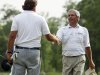 Phil Mickelson, left, shakes hands with Fred Couples on the ninth green after completing the second round of the Houston Open golf tournament, Friday, March 30, 2012, in Humble, Texas. (AP Photo/Eric Kayne)