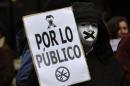 A protestor wears a mask during a demonstration against government austerity measures and the passing of a new law which toughens penalties on protesters, in Oviedo