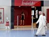 Emirati men look at a lingerie display as he passes in front of Frederick's of Hollywood at a shopping mall in Abu Dhabi, United Arab Emirates, Sunday July 31, 2011. The lingerie retailer Frederick's of Hollywood, has chosen Abu Dhabi for the launch of its first international store. The choice of venue is revealing, not only about demand for risque unmentionables on the Arabian Peninsula, but also for what it says about the United Arab Emirates' retail pull. In only a few short years, this desert country has emerged as an unlikely first port of call for retailers looking to test their brands overseas. (AP Photo/Kamran Jebreili)